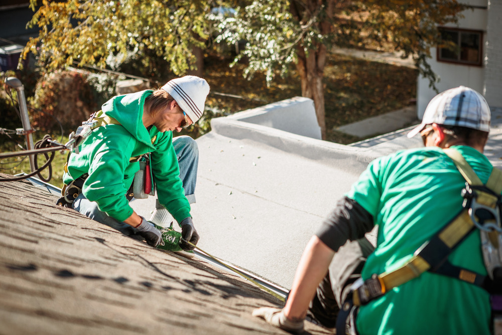 solar-panel-installation-crew-members-on-roof-of-h-2023-11-27-04-50-20-utc (1)